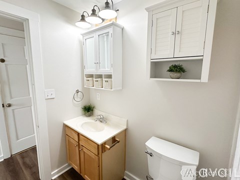 A small bathroom with a white toilet and a sink.