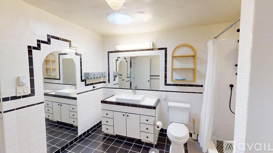 A bathroom with a white toilet, sink, and mirror.