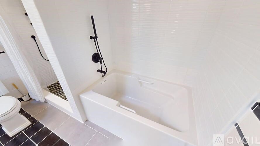 A white bathroom with a toilet, a sink, and a bathtub.