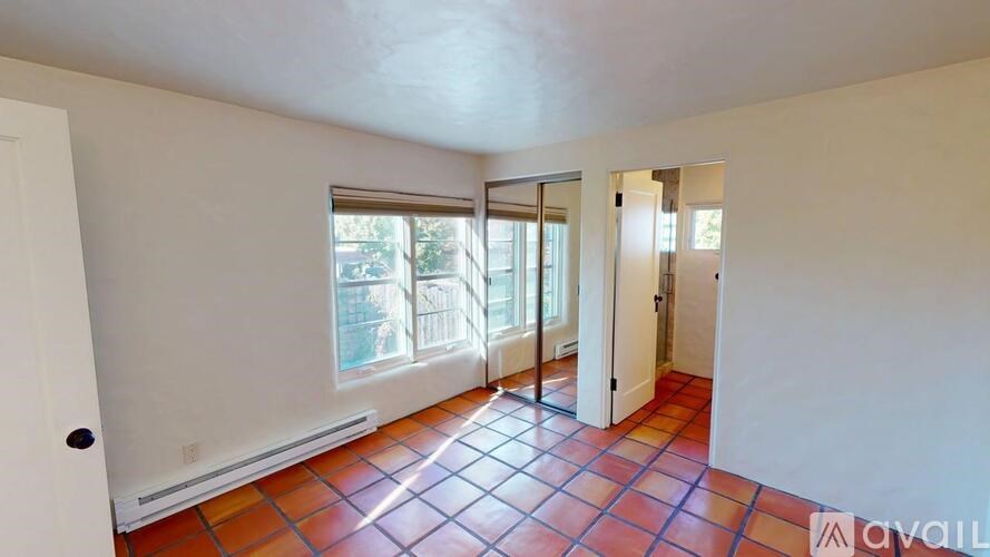 A room with a tiled floor and sliding glass doors.
