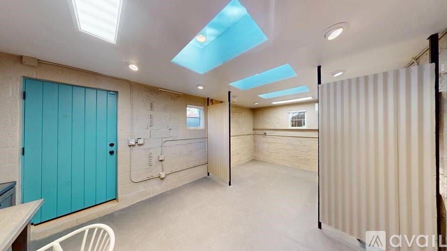 A room with a blue door and a white chair.