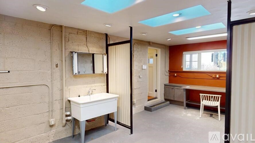 A bathroom with a skylight and a white sink.