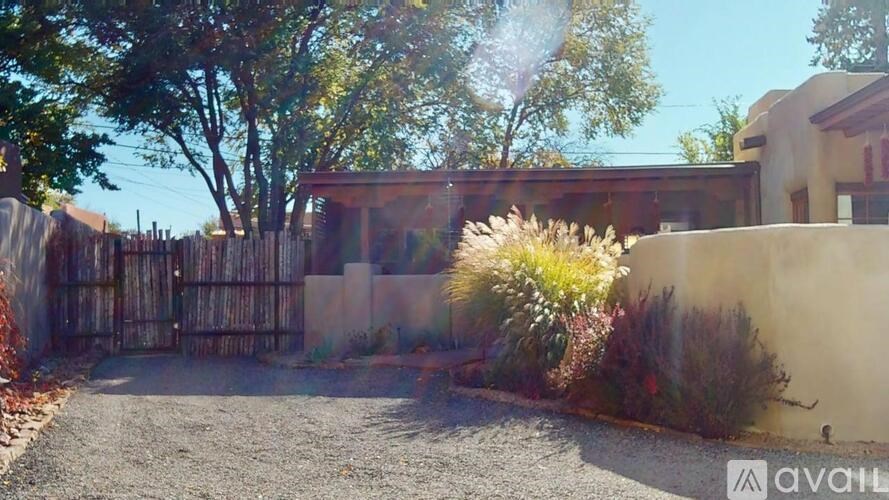 A house with a driveway and a fence is available for sale.