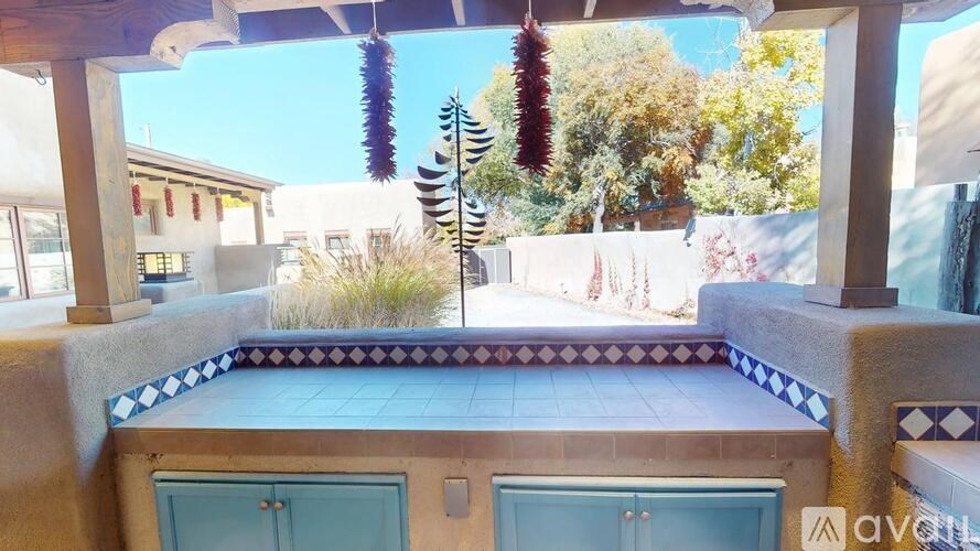 A balcony with a blue tile border and a zebra decoration.