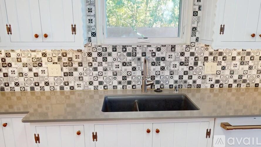 A kitchen with a sink and a window.