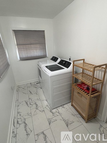 A small room with a hot tub and a wooden shelf.