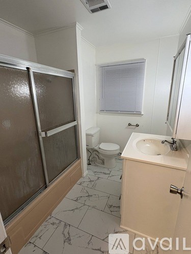 A bathroom with a sink, toilet, and shower.