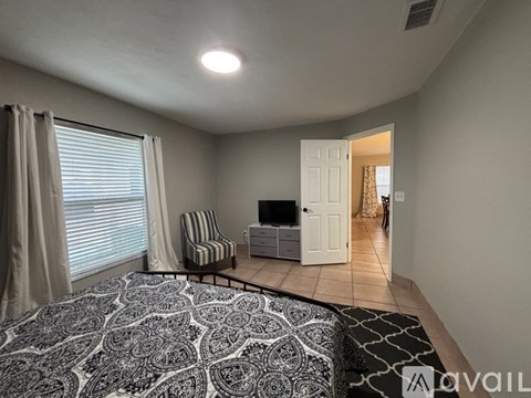 A living room with a patterned carpet and a striped chair.