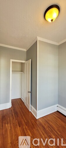 A room with wooden floors and a white door.