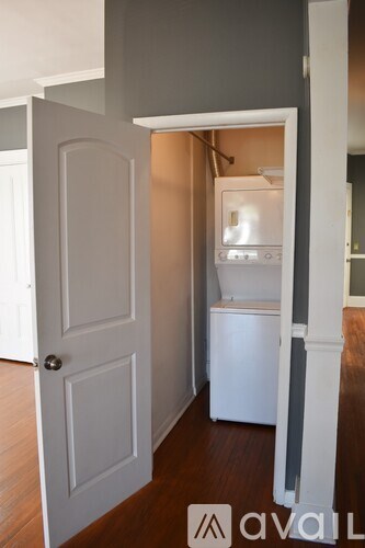 A white door is open to a small bathroom.