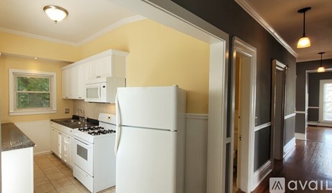 A kitchen with a white refrigerator and a stove top oven.