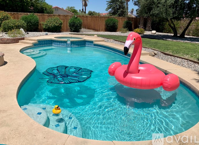 A pink flamingo float in a blue pool.