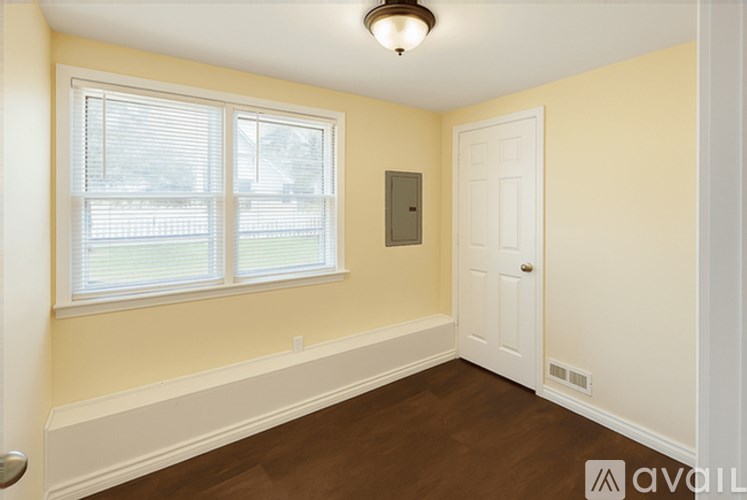 A room with a window and a door.