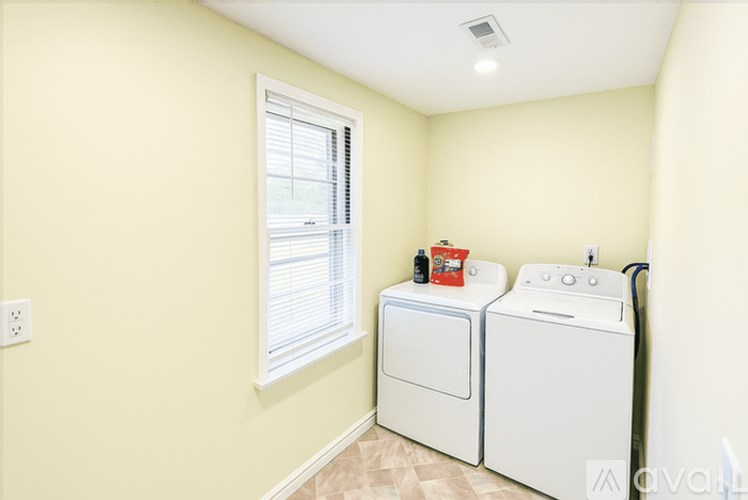 A small laundry room with a washer and dryer.