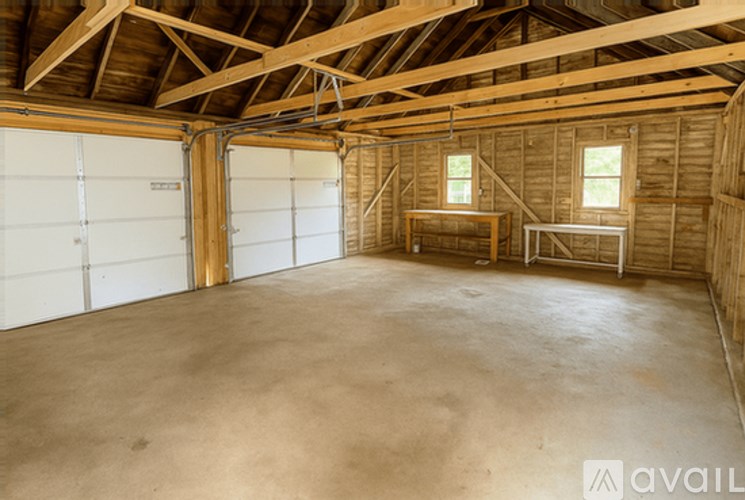 A large empty room with wooden walls and a high ceiling.