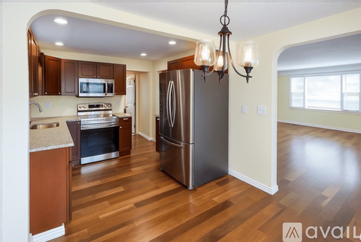 A kitchen with a refrigerator, stove, and microwave.