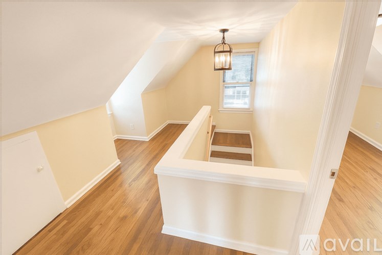 A room with wooden floors and a window.