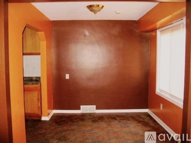 A room with brown walls and a brown floor.