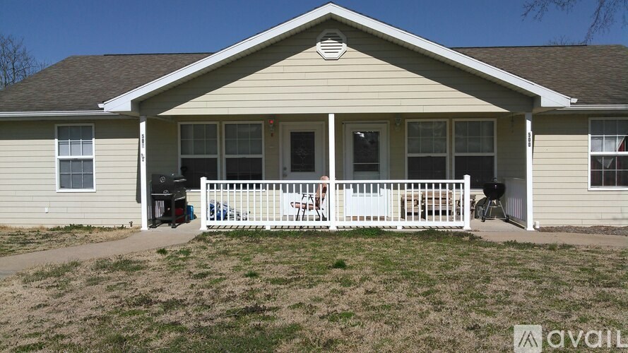 A house with a white fence and a sign that says "available" in front of it.