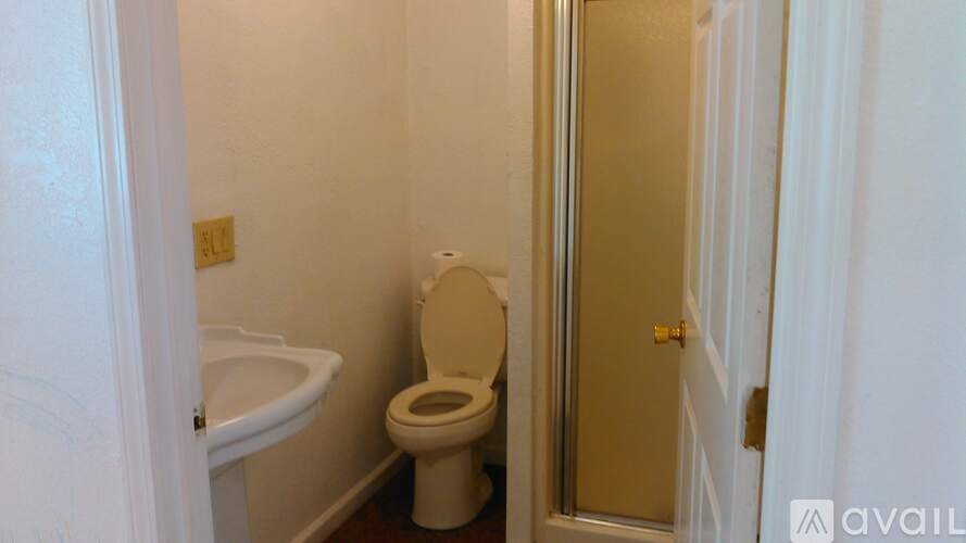 A white toilet in a small bathroom.
