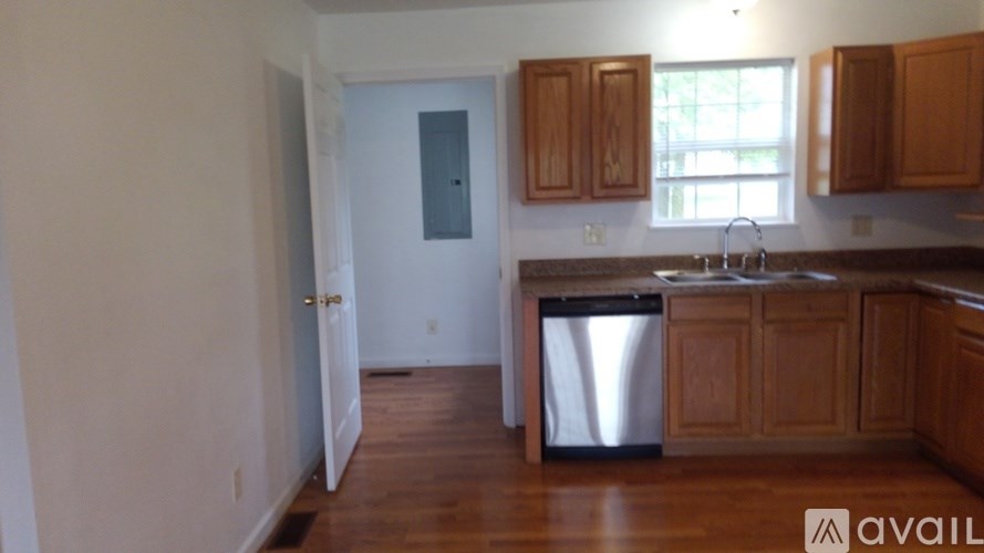 A kitchen with wooden cabinets and a dishwasher.