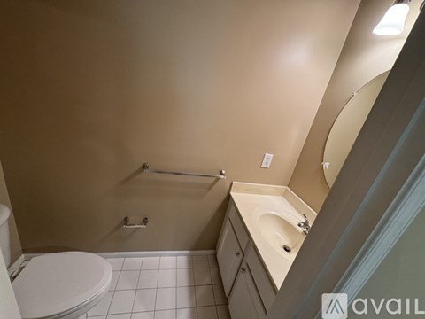 A bathroom with a toilet, sink, and shower.