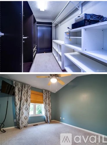 A room with a ceiling fan and a window with curtains.