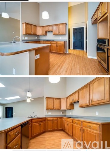 A kitchen with wooden cabinets and a blue door.