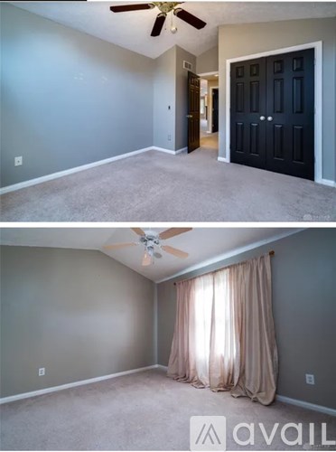 A room with a ceiling fan and a door.