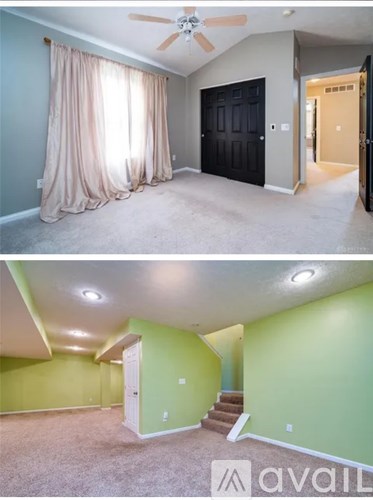 A room with a ceiling fan and a staircase.