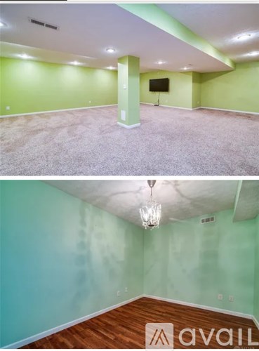 A room with a wooden floor and a television mounted on the wall.