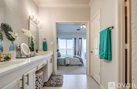 A well-lit, spacious hallway with a mirror, a bed, and a rug.
