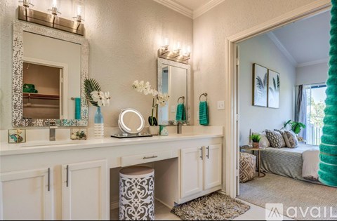 A vanity with a mirror and lights above it.