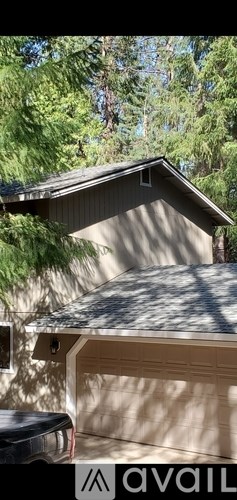 A house with a garage door and a roof.
