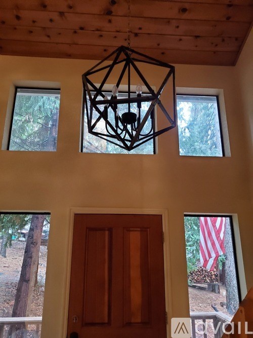 A room with a wooden ceiling and a wooden door.