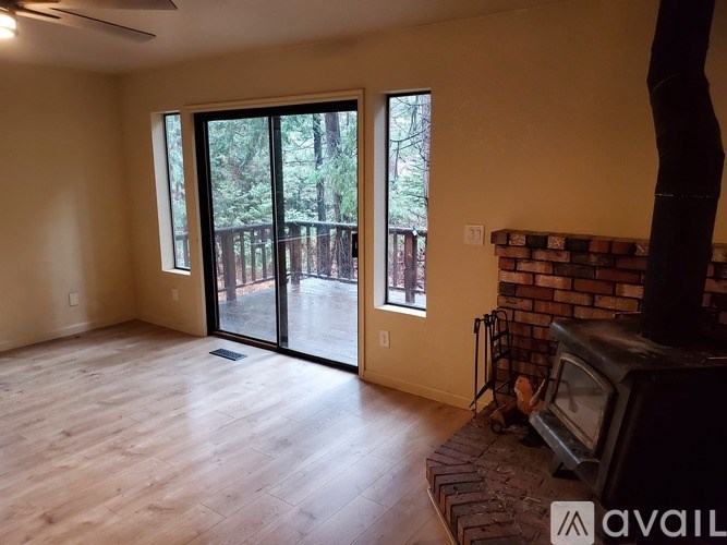 A living room with a fireplace and sliding glass doors.