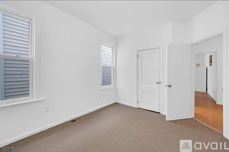 A room with white walls and a carpeted floor.