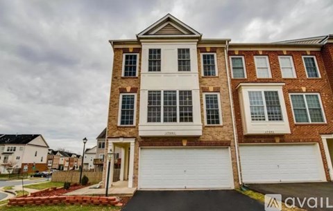 A two-story house with a garage is available for purchase.