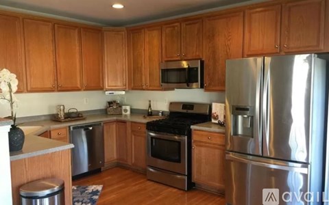 A kitchen with wooden cabinets and stainless steel appliances.