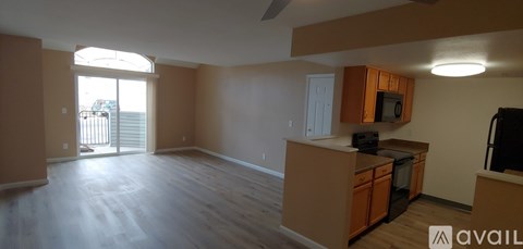 A kitchen with wooden cabinets and a black stove top oven.
