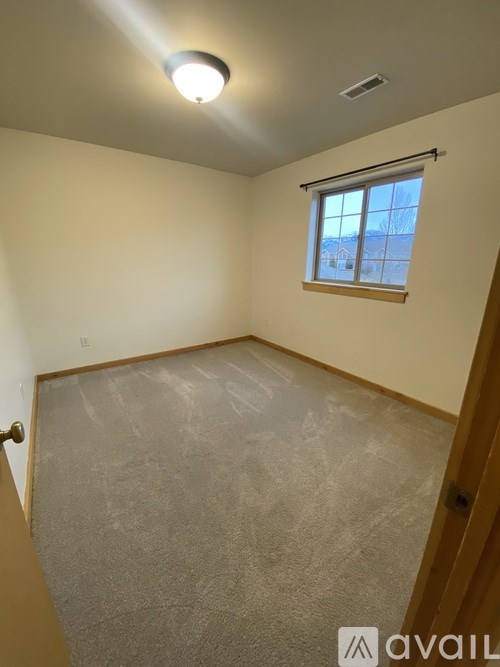 A room with a window and a door.