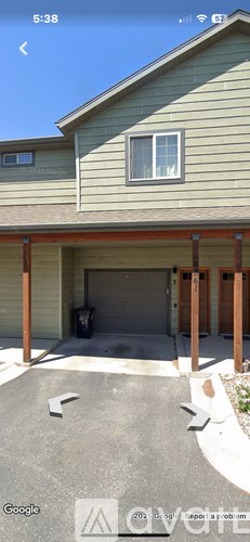 A house with a garage and a driveway.