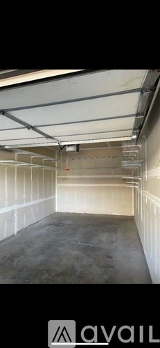 A spacious garage with a concrete floor and white walls.