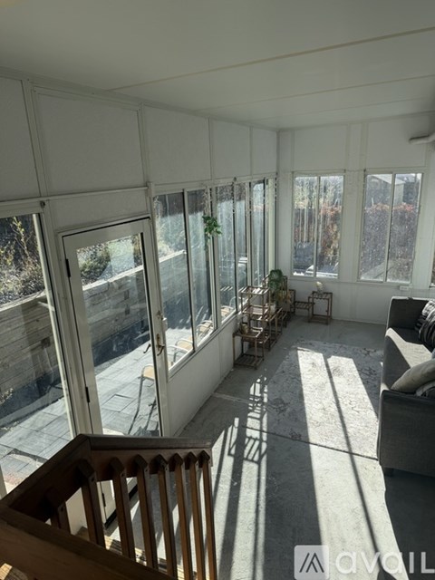 A living room with a couch and a staircase.