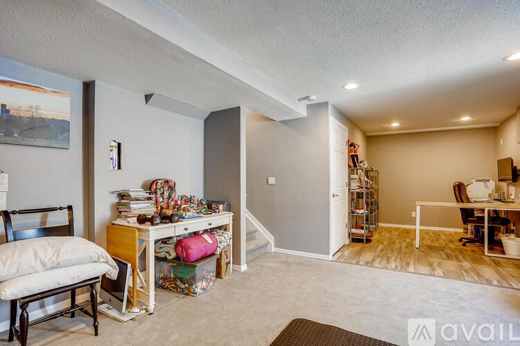 A room with a desk and a chair in it.