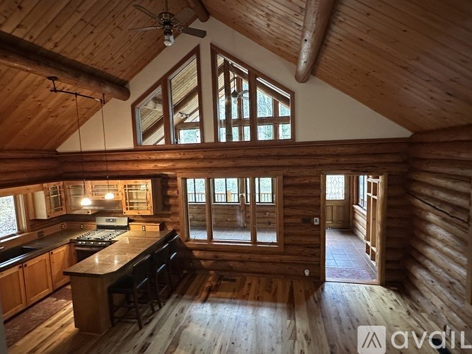 A wooden cabin with a bar and a window.