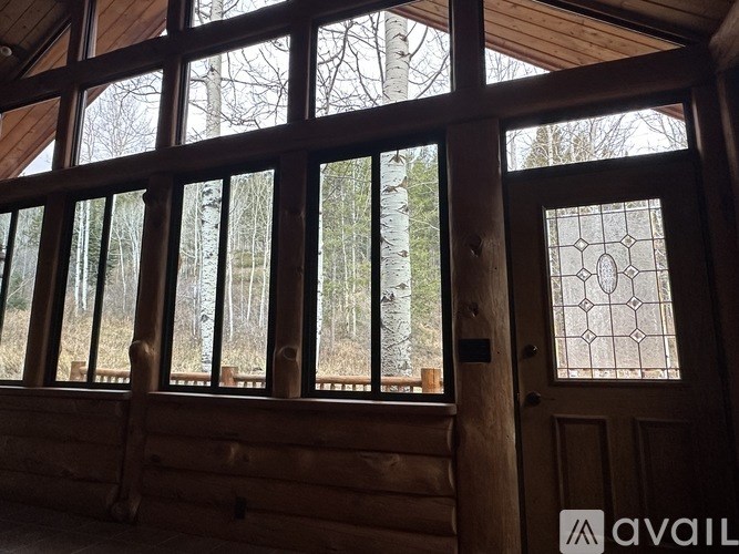A wooden door with a glass window and a wooden wall.