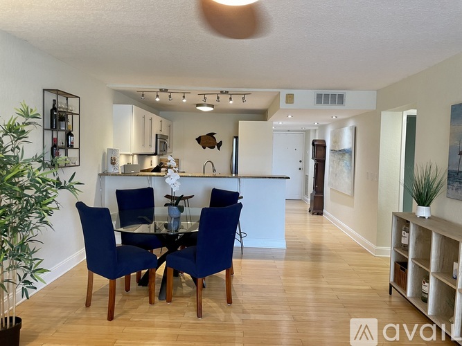 A dining room with a table set for four.