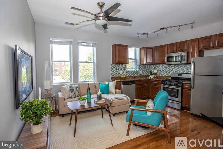 A kitchen with a refrigerator, oven, and a dining table with chairs.