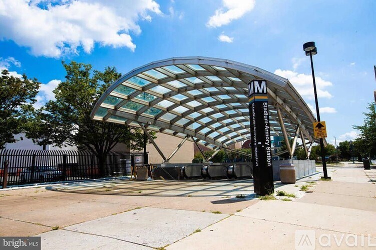 A modern building with a glass facade and a curved roof.